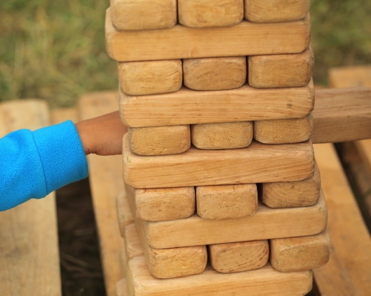 Playing a game of outdoor Jenga