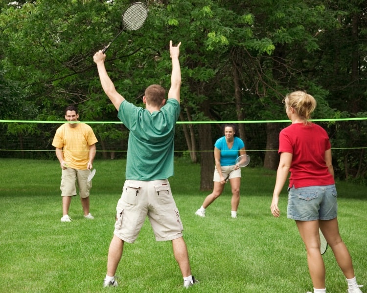 Portable badminton net in backyard